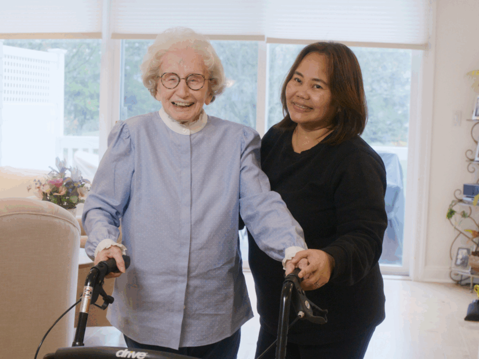 Ecstatic smiling senior woman with her smiling caregiver, enjoying companionship